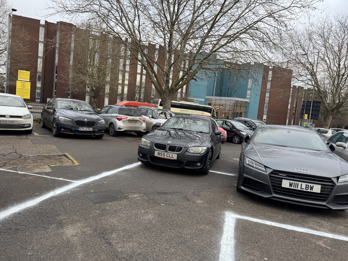 A badly parked black BMW at Tower Ramparts car park in Ipswich